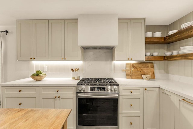 kitchen featuring decorative backsplash, wooden counters, and gas stove