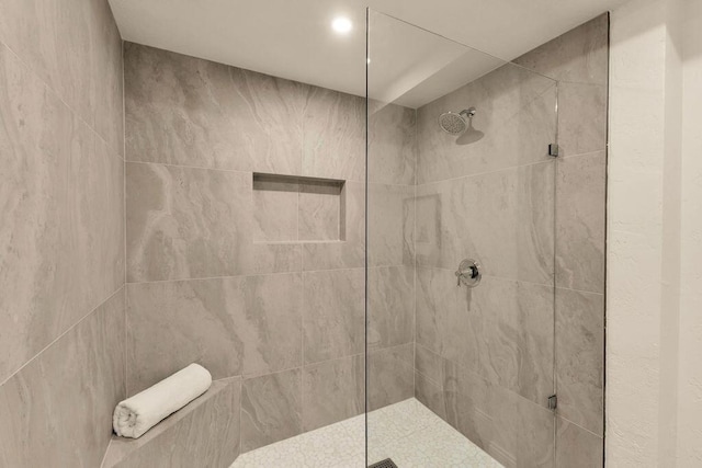 bathroom with tiled shower