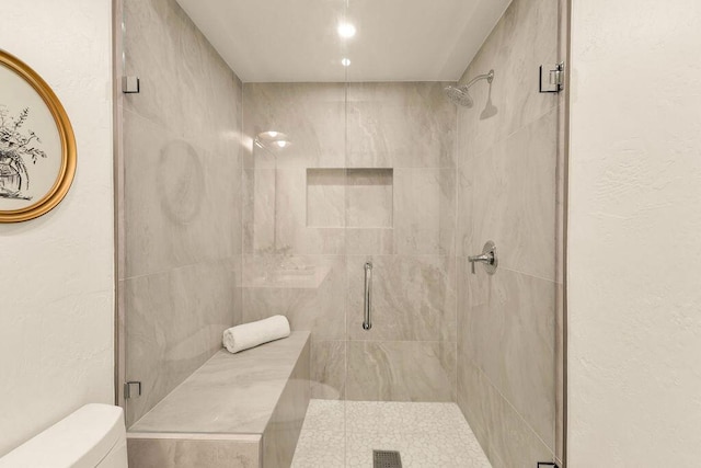 bathroom with an enclosed shower and toilet