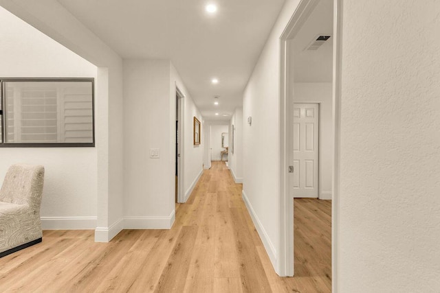 hall with light wood-type flooring