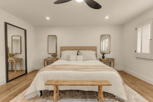 bedroom with ceiling fan and light wood-type flooring