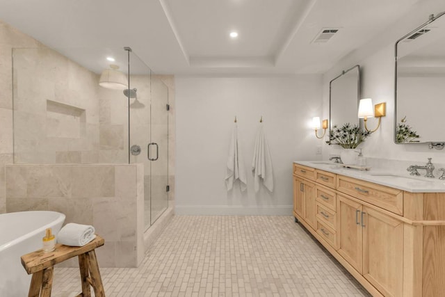 bathroom with tile patterned flooring, vanity, a raised ceiling, and plus walk in shower