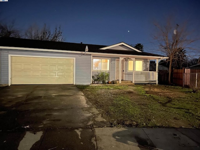 ranch-style house with a garage and covered porch