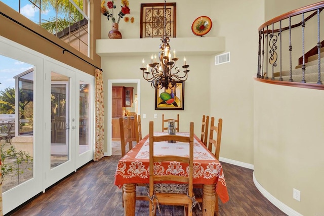 dining room with dark hardwood / wood-style floors, a chandelier, and french doors