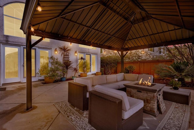 view of patio featuring a gazebo and an outdoor living space with a fire pit