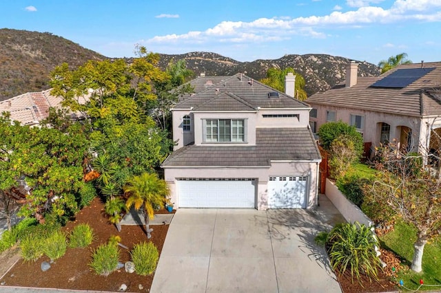 view of property featuring a mountain view and a garage