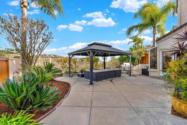 view of patio with an outdoor living space, a gazebo, and a mountain view