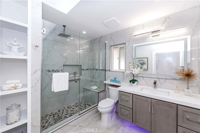 bathroom featuring walk in shower, vanity, toilet, and tile walls