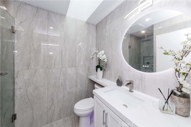 bathroom with vanity, tile walls, an enclosed shower, and toilet