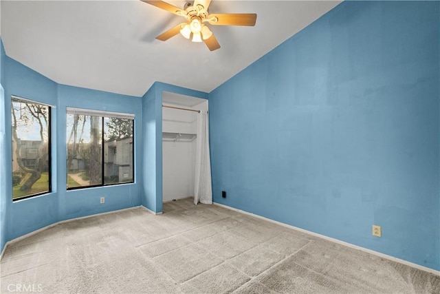 unfurnished bedroom with ceiling fan, a closet, and light colored carpet