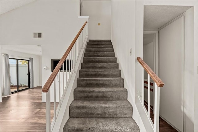 stairs featuring hardwood / wood-style floors