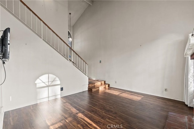 unfurnished living room with high vaulted ceiling, dark hardwood / wood-style flooring, and beamed ceiling