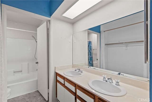 full bathroom with toilet, vanity, a skylight, and shower / tub combo