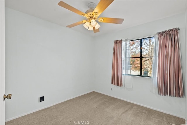 unfurnished room featuring ceiling fan and light colored carpet