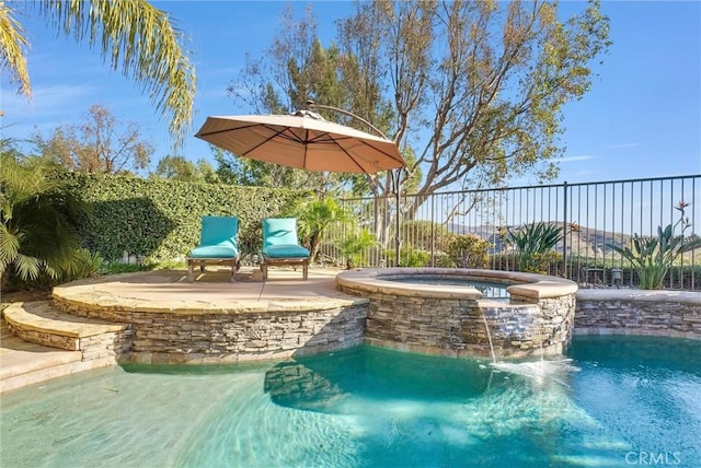 view of swimming pool with an in ground hot tub