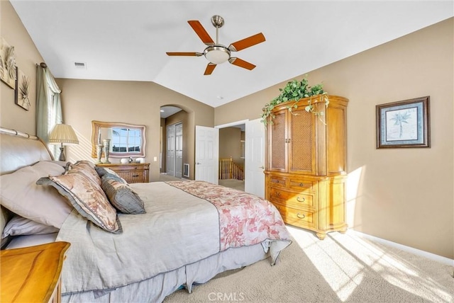 carpeted bedroom with ceiling fan and lofted ceiling