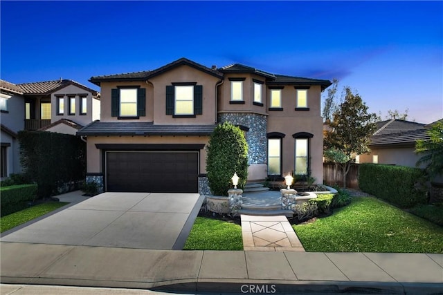 view of front of home featuring a yard and a garage