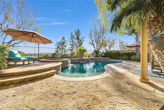 view of pool featuring pool water feature, a patio area, and an in ground hot tub