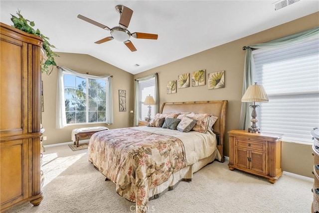 carpeted bedroom featuring ceiling fan and vaulted ceiling