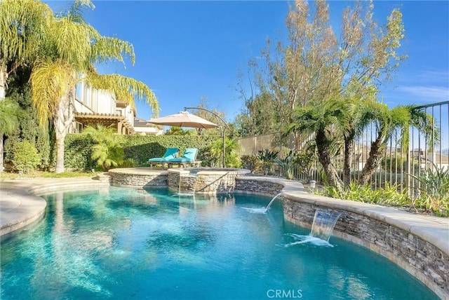 view of swimming pool with an in ground hot tub and pool water feature