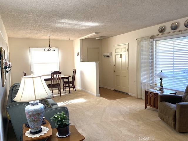 living room featuring a textured ceiling and light colored carpet