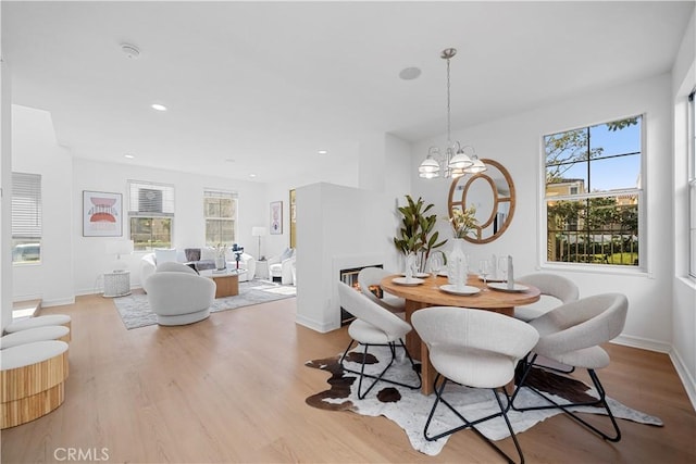 dining room with an inviting chandelier and light hardwood / wood-style floors