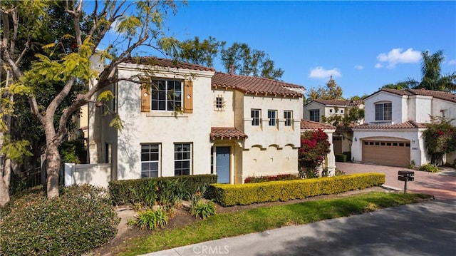 mediterranean / spanish-style house featuring a garage