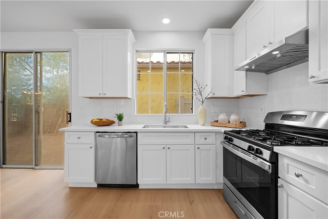 kitchen featuring light hardwood / wood-style floors, sink, white cabinetry, and stainless steel appliances