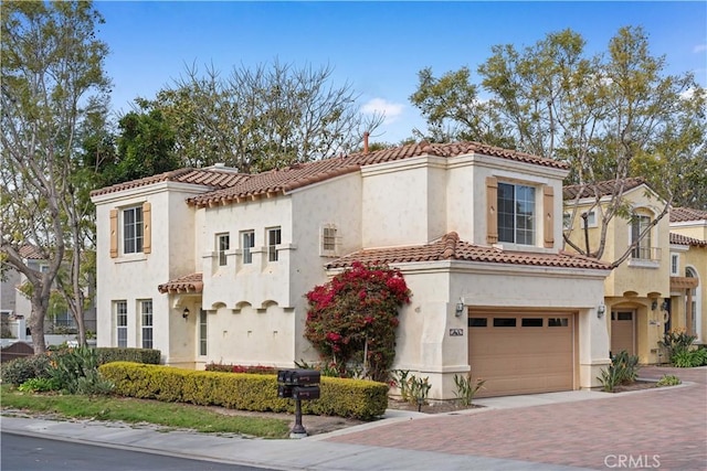 mediterranean / spanish-style house with a garage