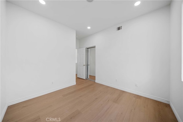 empty room with light hardwood / wood-style floors