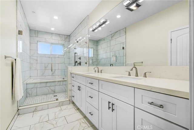 bathroom with a shower with door and vanity