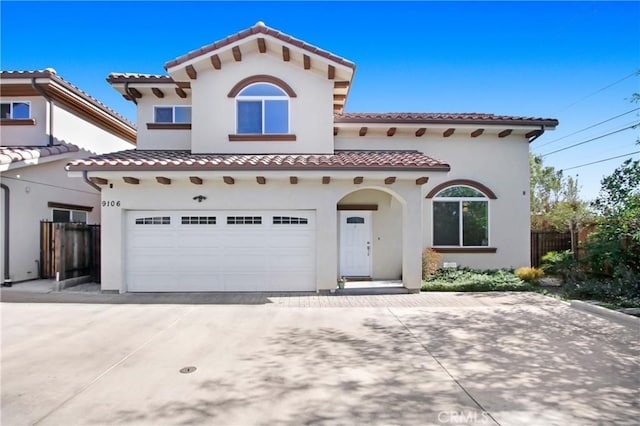 mediterranean / spanish home featuring a garage