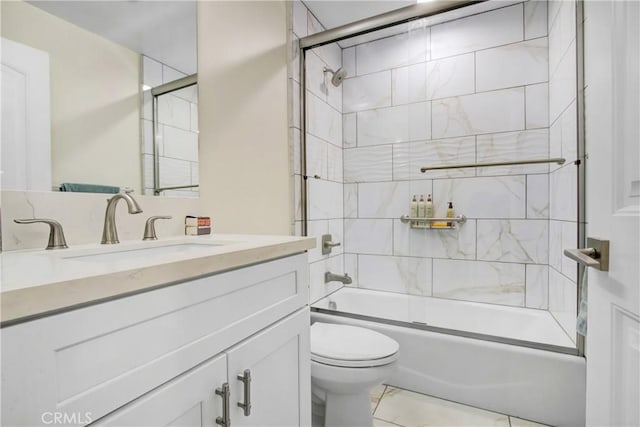 full bathroom featuring toilet, vanity, and shower / bath combination with glass door