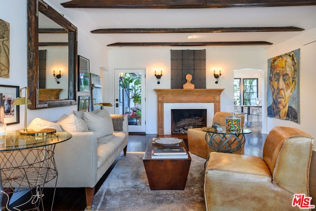 living room featuring beam ceiling and dark hardwood / wood-style floors