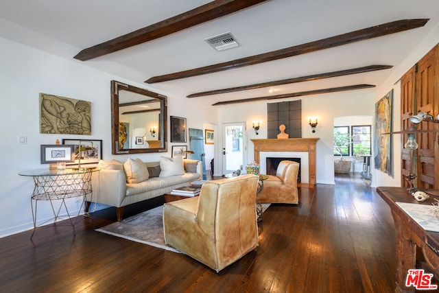 living room featuring dark hardwood / wood-style floors and beamed ceiling