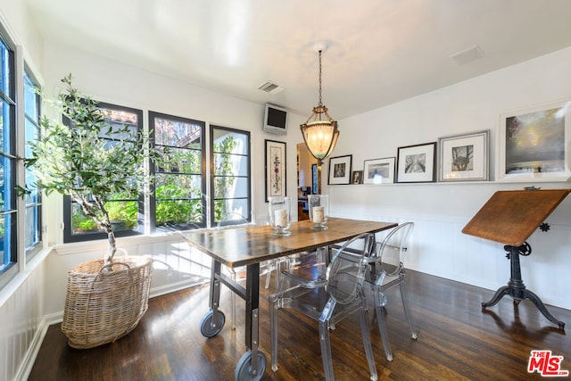 dining area featuring dark wood-type flooring