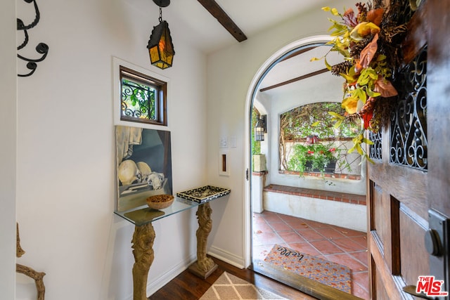 foyer entrance with beam ceiling and hardwood / wood-style floors