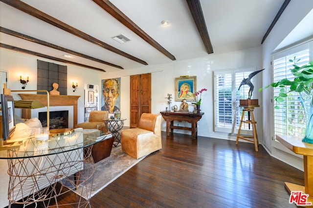 living room with dark hardwood / wood-style floors and beamed ceiling