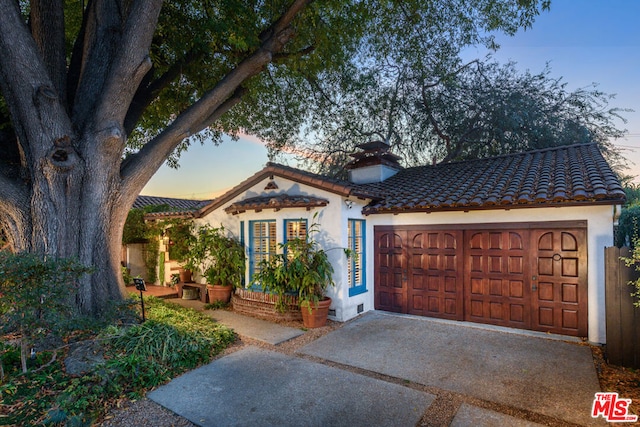 mediterranean / spanish home featuring a garage