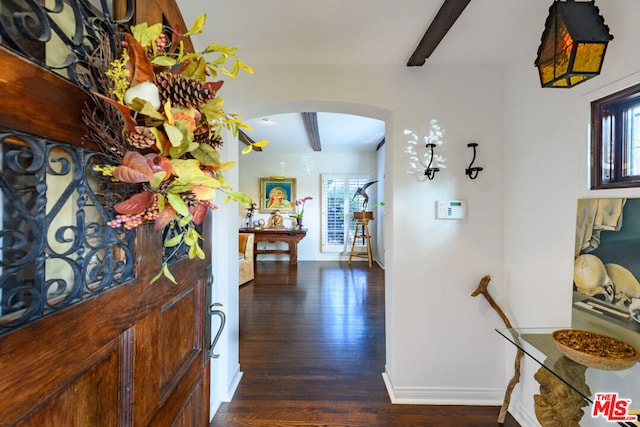 foyer entrance featuring dark wood-type flooring and beamed ceiling