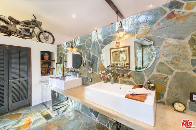 bathroom featuring vaulted ceiling with beams