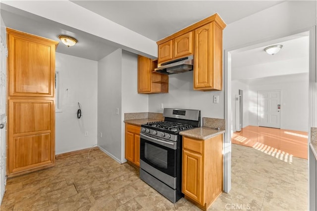 kitchen featuring stainless steel gas range and stone counters