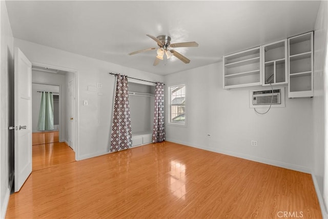 interior space featuring ceiling fan, a closet, cooling unit, and light hardwood / wood-style floors