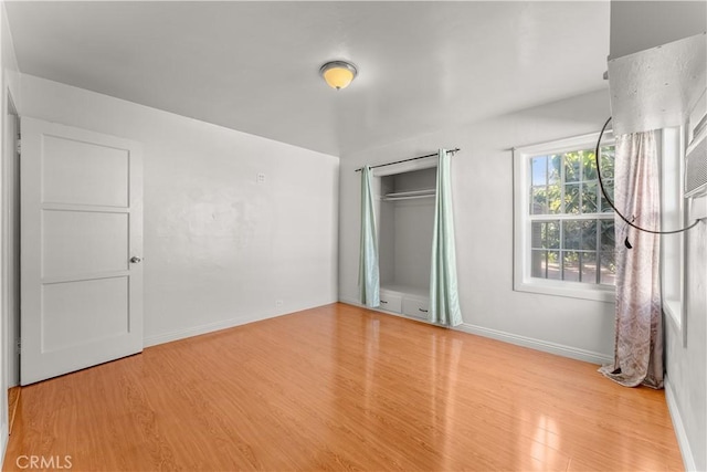 unfurnished bedroom featuring a closet and light hardwood / wood-style flooring