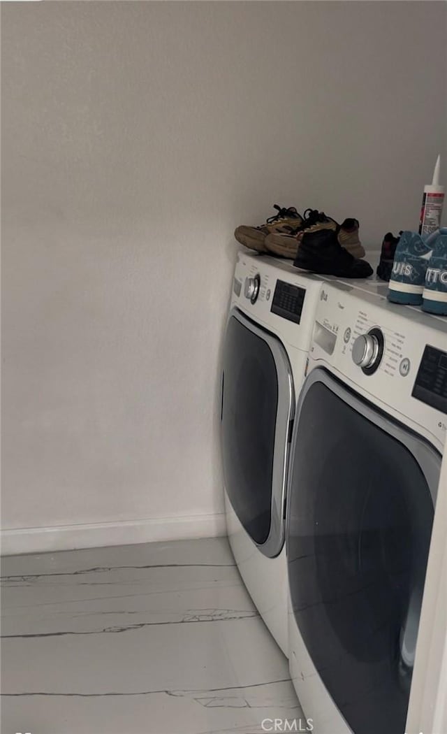 clothes washing area featuring washing machine and dryer