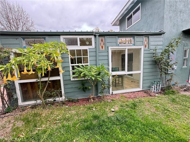 rear view of property with a yard