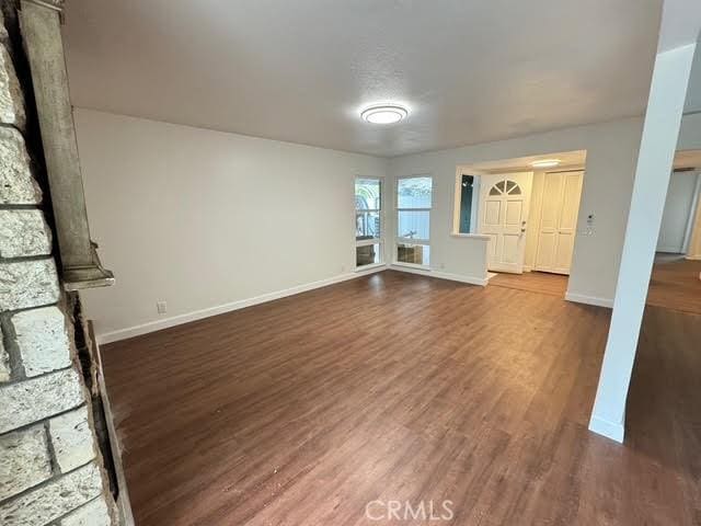 unfurnished living room featuring dark hardwood / wood-style floors