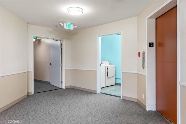 empty room with washing machine and clothes dryer and elevator