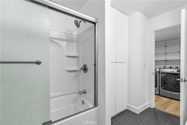 bathroom with shower / bath combination, tile patterned floors, and washer and dryer