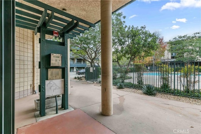 view of patio with a pergola and a community pool